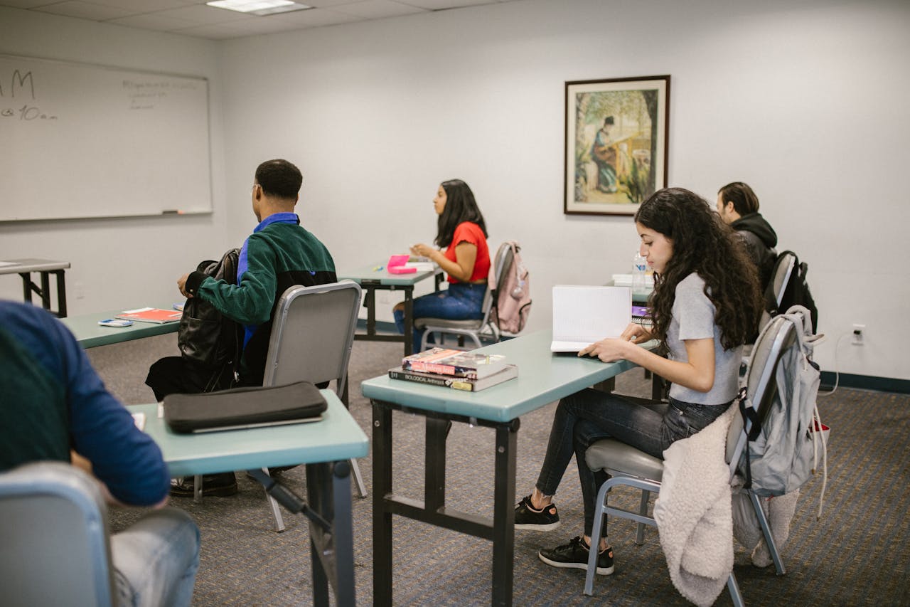 get-in-touch Students engaged in study inside a college classroom with books and discussions.